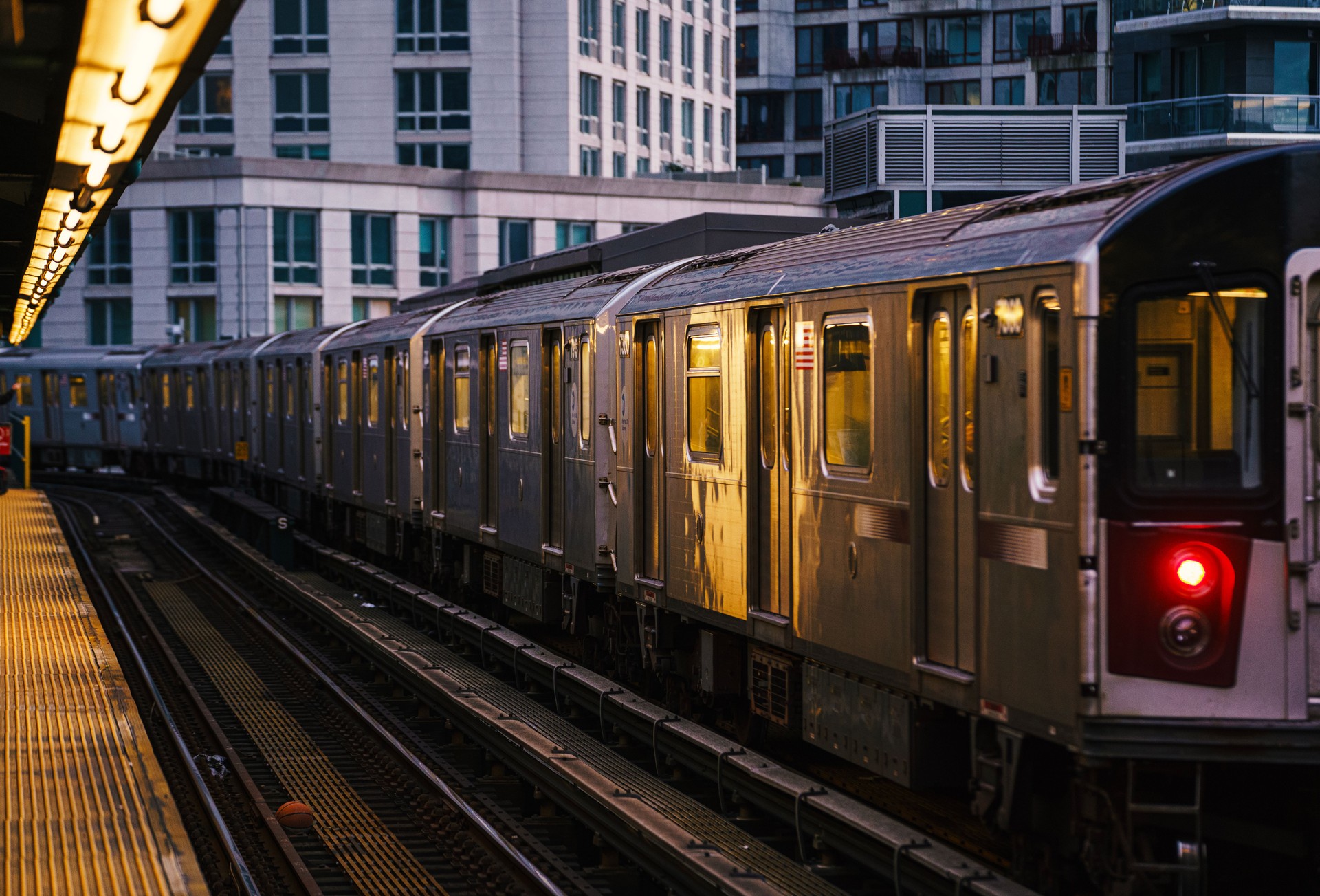 Elevated subway train during sunset in Queens, New York City